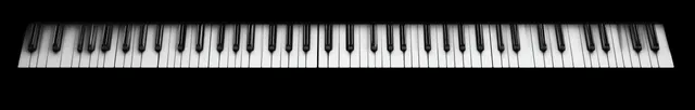 Black and white piano keys arranged horizontally across a black background with visible surface texture.