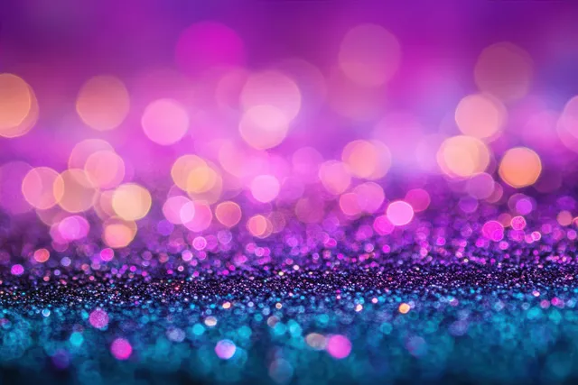 Vibrant abstract glitter texture with purple, pink, and blue bokeh lights creating a dreamy, softly blurred atmosphere.