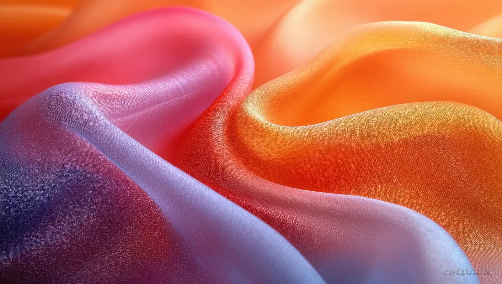 Colorful silk scarf folds swirl across an orange and pink background.