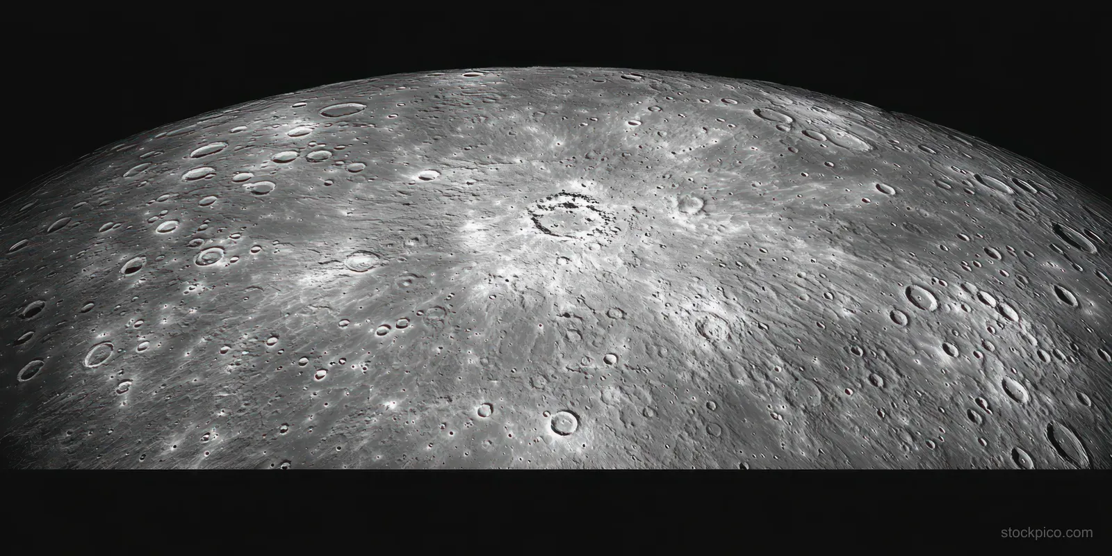Close-up of a cratered lunar surface lit from the side against black space.