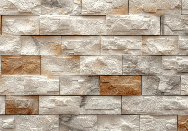 Close-up view of a cream and beige stone brick wall texture with smooth mortar joints and varied weathering.