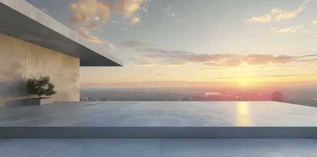 Empty concrete rooftop platform with overhang, city skyline, and sunset sky over the horizon.
