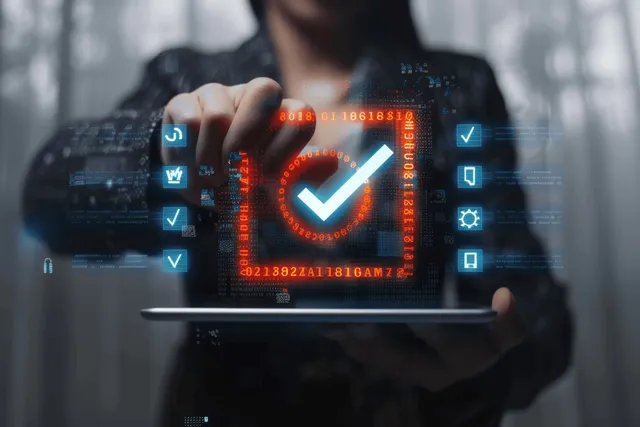 A business professional holds a tablet displaying a holographic quality control checklist with checkmarks and charts.