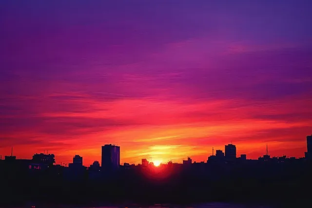 Skyscraper silhouettes appear along the horizon under an orange and purple sunset sky.