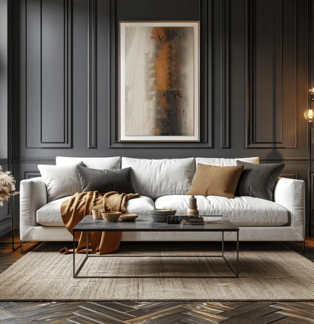 Modern living room with a white sofa, dark gray walls, framed artwork mockup, and a coffee table in warm light.