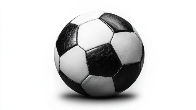Black and white leather soccer ball close-up on plain white background with soft shadow