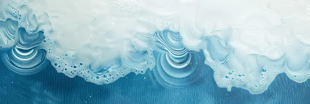 Top view of white sand and blue wave ripples with sunlit highlights, copy space