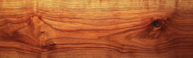 Smooth warm brown wooden planks with natural grain patterns and a few knots in closeup.
