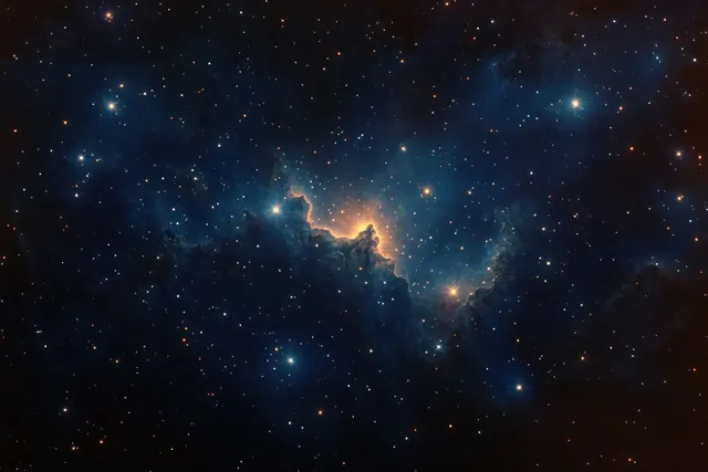 A glowing blue and orange nebula floats in deep space, surrounded by countless bright stars.