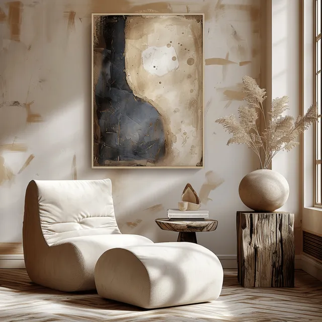 Beige armchair with wooden side table beside window, abstract wall art in neutral living room