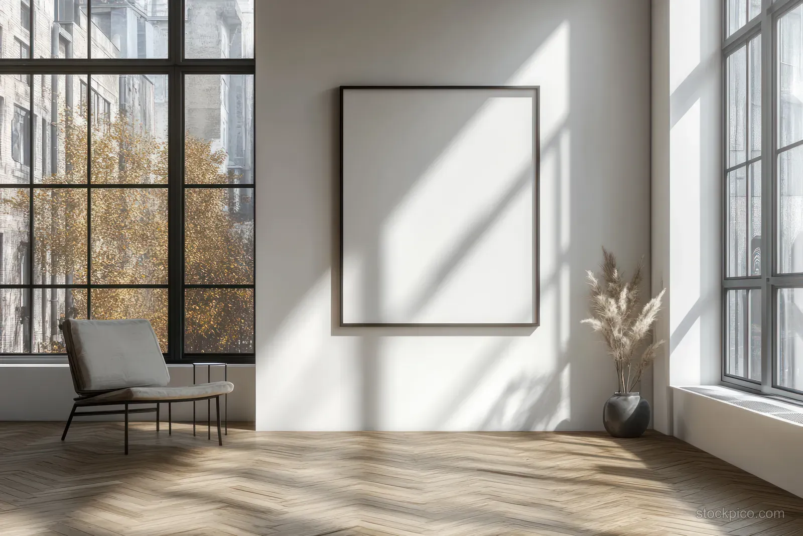 Blank picture frame on a white wall with sunlight beams and a herringbone wooden floor.