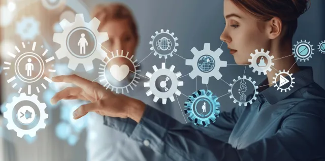 Business team points at engagement icons on a digital screen during a meeting