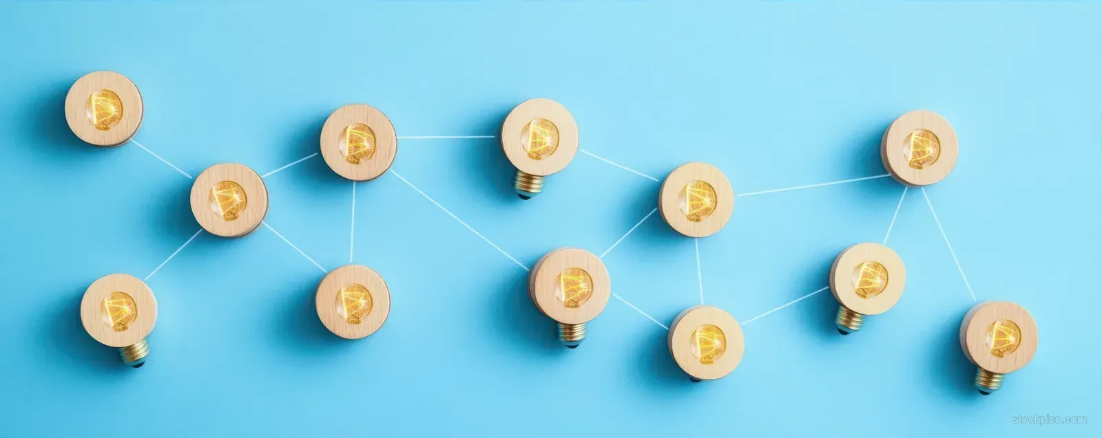 Glowing light bulbs connected by white lines on a blue background forming an idea network.