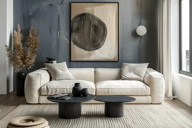 Beige sofa and black coffee table in a Scandinavian living room beneath a framed abstract poster on the wall.