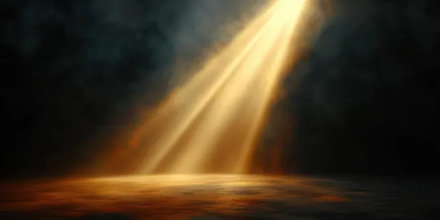 Golden spotlight beams illuminate a dark background and cast warm light rays onto an empty textured surface.