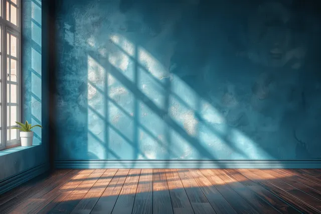 Minimal empty room with turquoise wall, wooden floor, and sunbeams entering from window