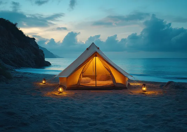 A glowing luxury glamping tent with fairy lights on a sandy beach facing the ocean at blue hour.