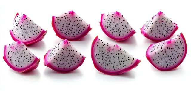 Eight dragon fruit slices with white flesh and pink rind, scattered on a white background with visible tiny black seeds.