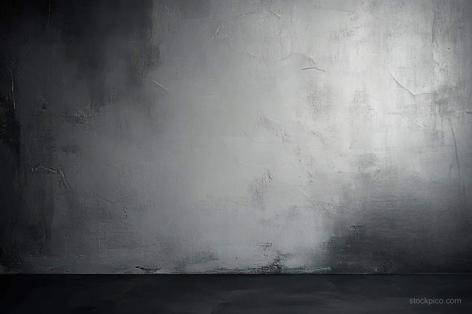 Empty textured concrete wall with worn plaster in grayscale lighting and a dark floor.