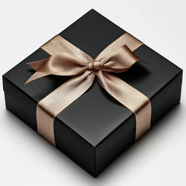Black gift box tied with shiny beige satin ribbon bow on clean white background