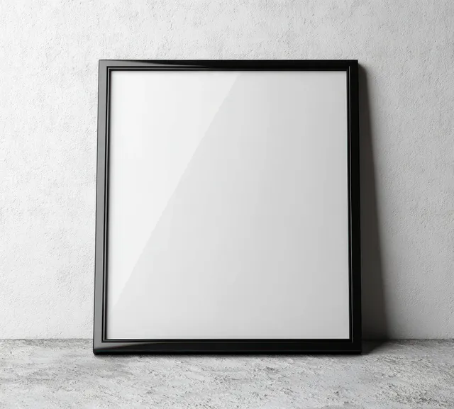 Square black picture frame mockup on a textured white wall under soft natural light.