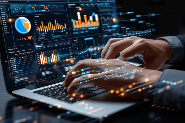 Hands on a laptop keyboard display sales analytics charts and dashboard graphs with bright data points.