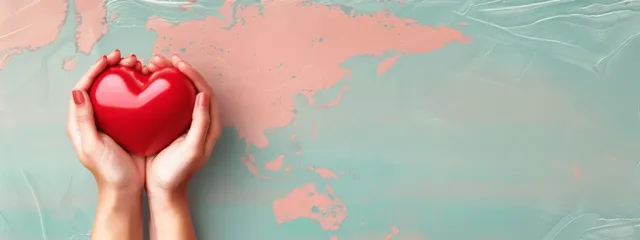 Woman holds glowing red heart above world map for global health awareness banner