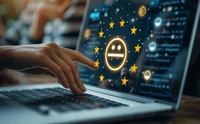 A person types on a laptop displaying a five-star rating and happy emoji for customer feedback.