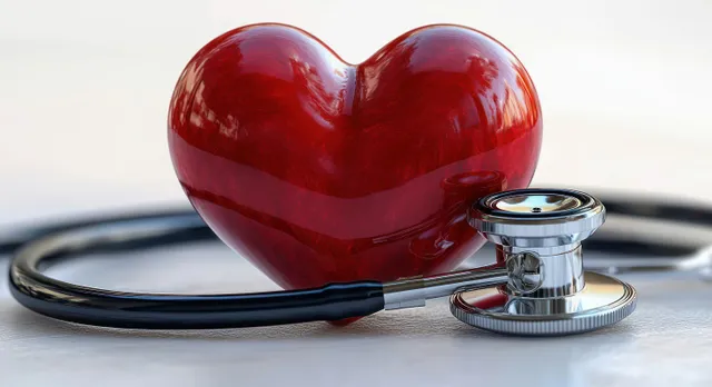 Shiny red heart sculpture beside metallic stethoscope on a pale clinical surface with Medical Diagnostics