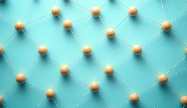 Wooden sphere network links on blue background with soft light and subtle shadows