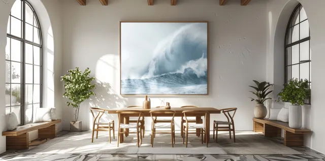 Wooden dining table set in a coastal room with arched windows and a framed sea landscape on the wall.