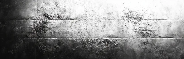 Rough black and white concrete wall with weathered patches and dark-to-light gradient lighting across the surface.