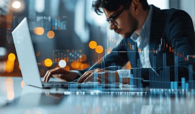 Businessman reviews financial charts on tablet and laptop in a city finance glow