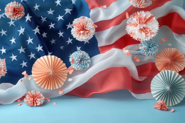 Red white blue American flag fabric covered with paper fans and pom-poms on a light blue background.