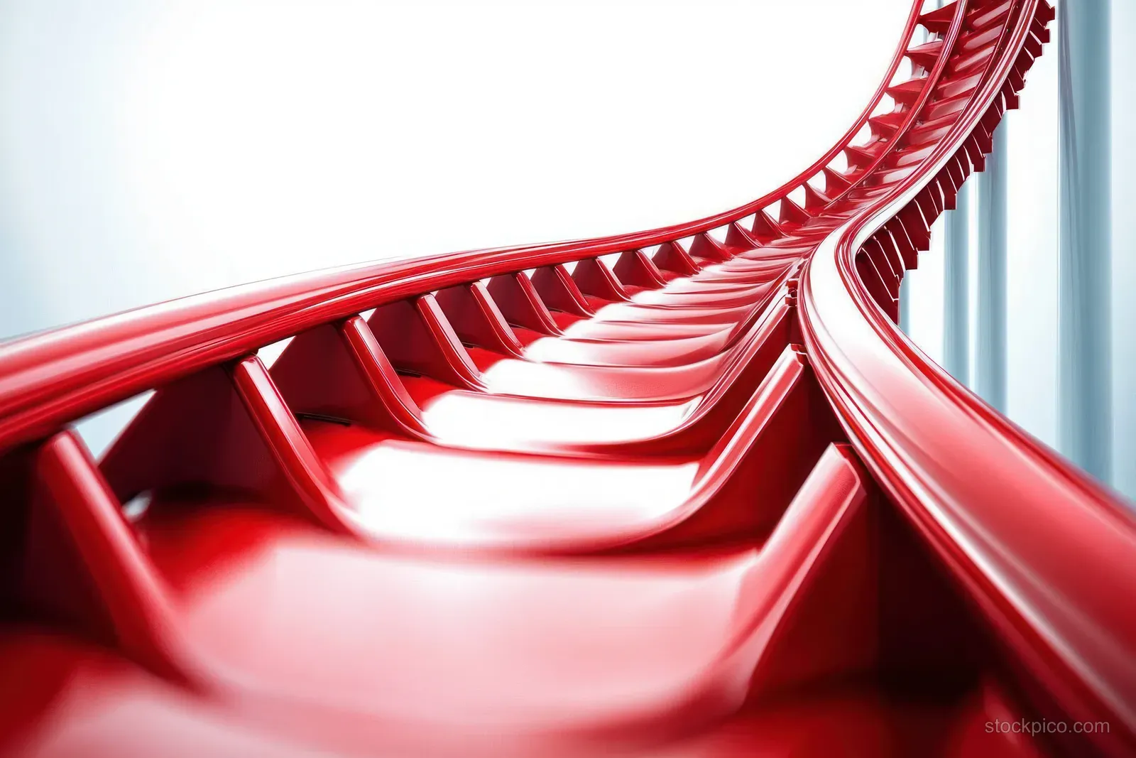Close-up of a shiny red roller coaster track curving upward with looping rails against a pale background.