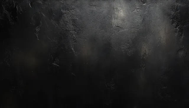 Moody black grunge wall texture with soft gray haze and dark vignette