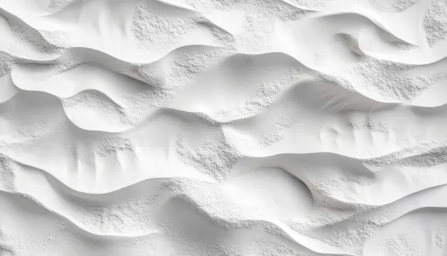 Monochrome white sand ripple pattern with sharp shadows across a desert-like surface