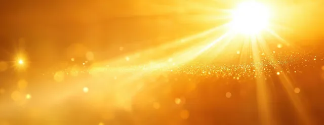 Abstract sunburst with glowing light rays in vibrant yellow and amber tones on a bright background.