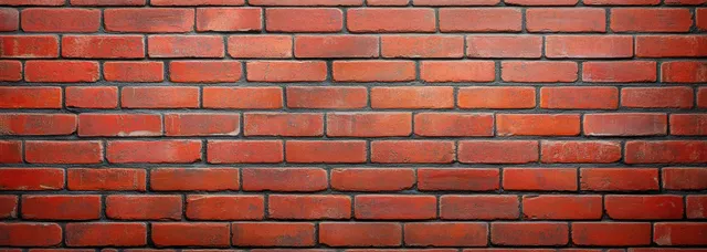 A wide red brick wall background with rough texture and horizontal mortar lines.