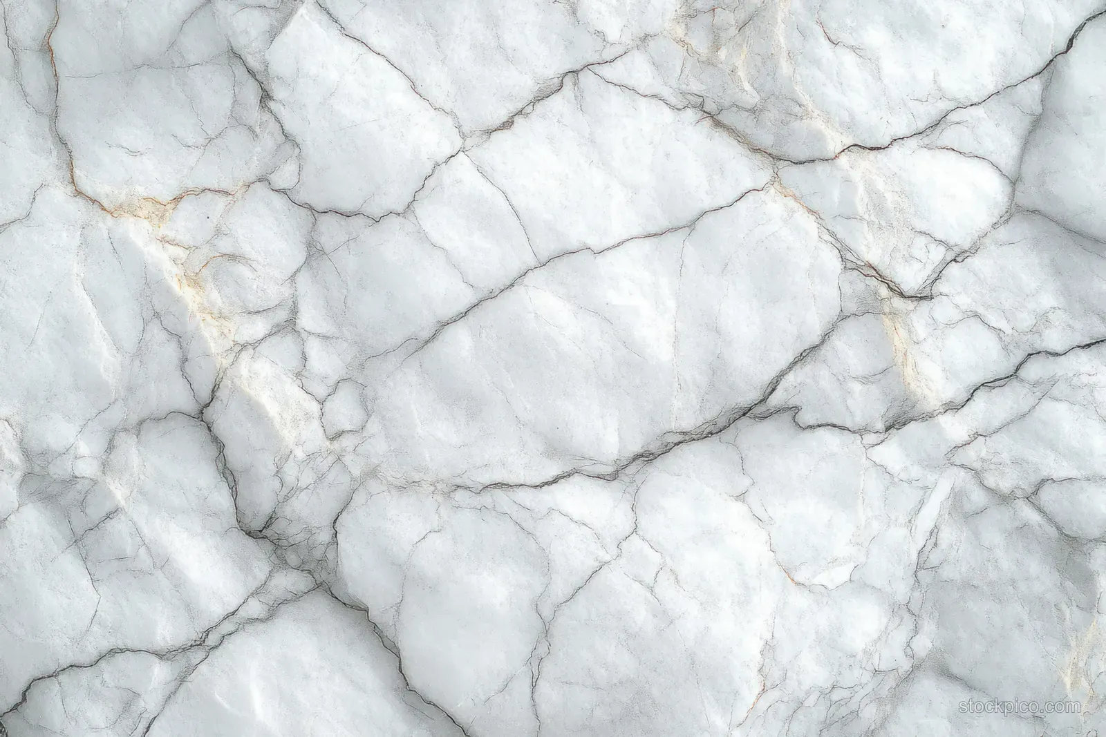 White marble surface close-up with gray cracks and faint golden veins forming a natural stone texture.
