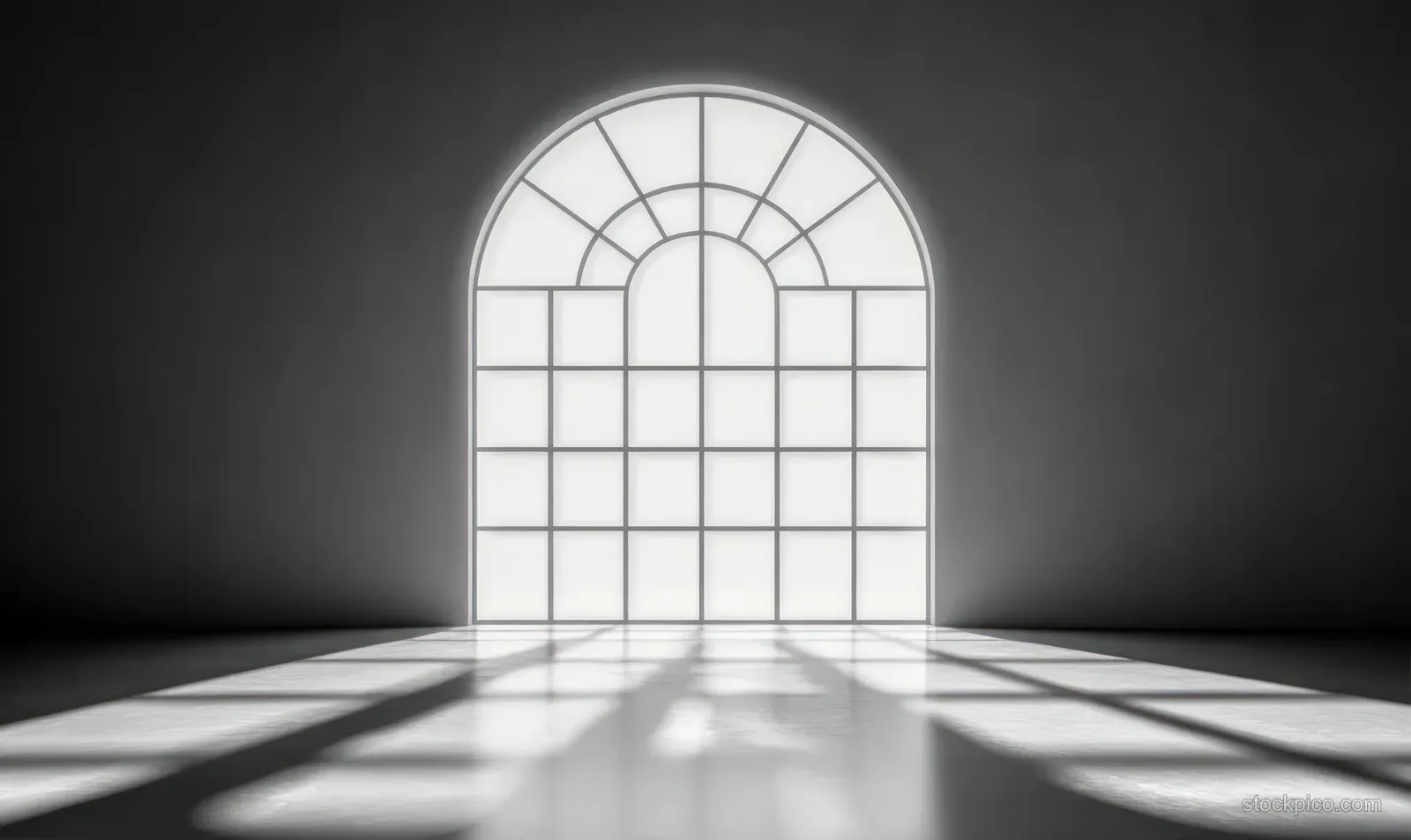Sunlight from a large arched window casts geometric shadows onto an empty smooth floor in a minimal room.