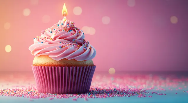 Pink Frosted Birthday Cupcake with Candle and Sprinkles