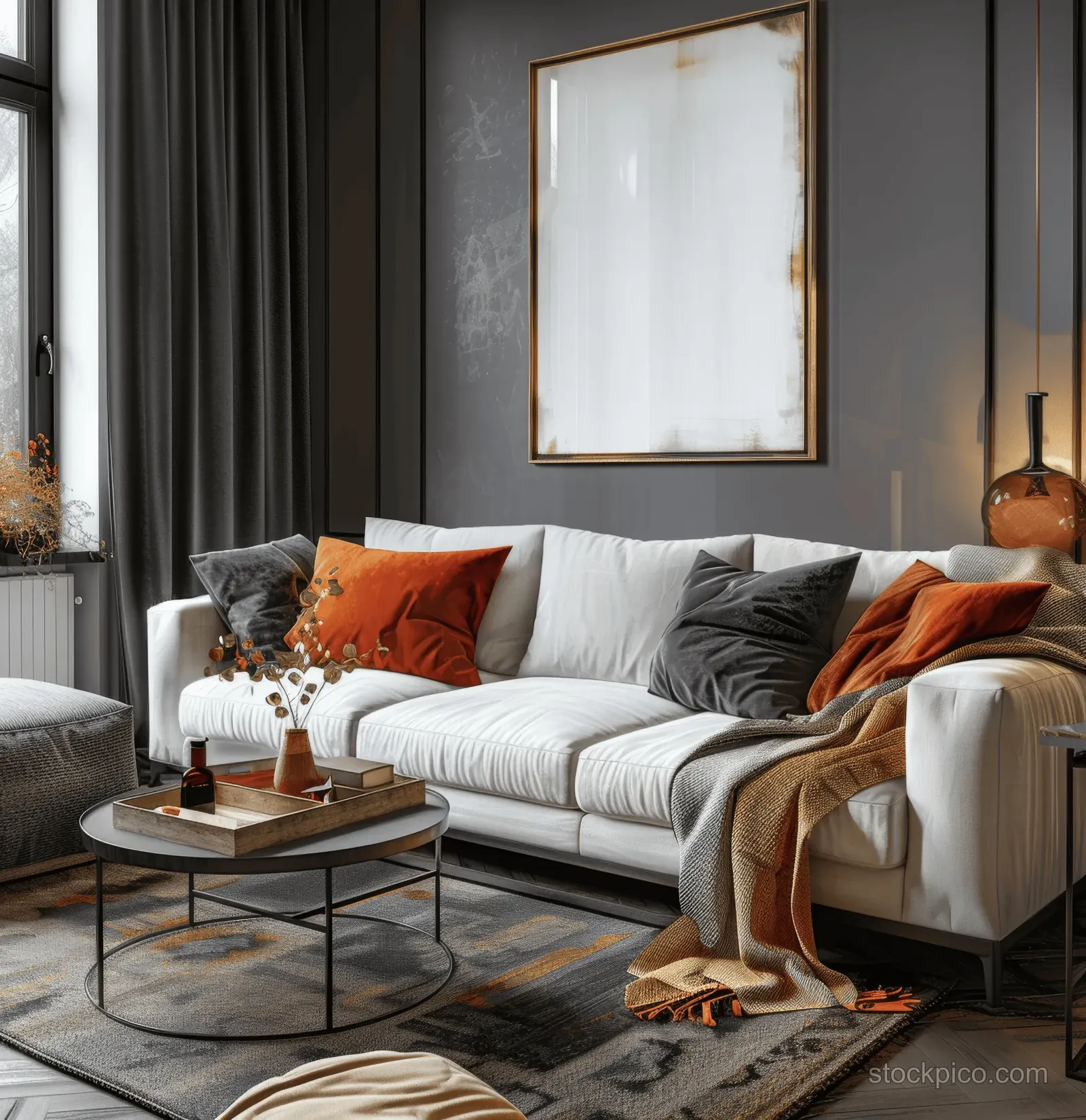 White sofa in a dark modern living room with orange pillows, warm lamps, and a framed wall print.