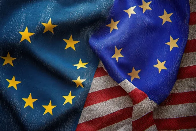 Overlapping EU and US flags with visible fabric folds and yellow stars on blue.
