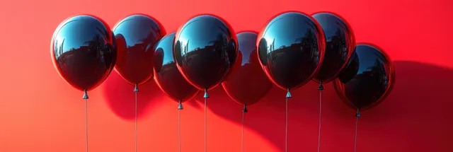 Black and red balloons tied along string against a bold red gradient backdrop