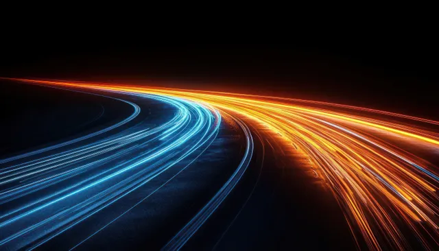 Long exposure light trails curve along a dark highway with electric blue and orange neon streaks.