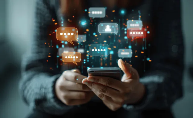 A businessman engages in live chat marketing using a smartphone, surrounded by chat bubbles and network connections.