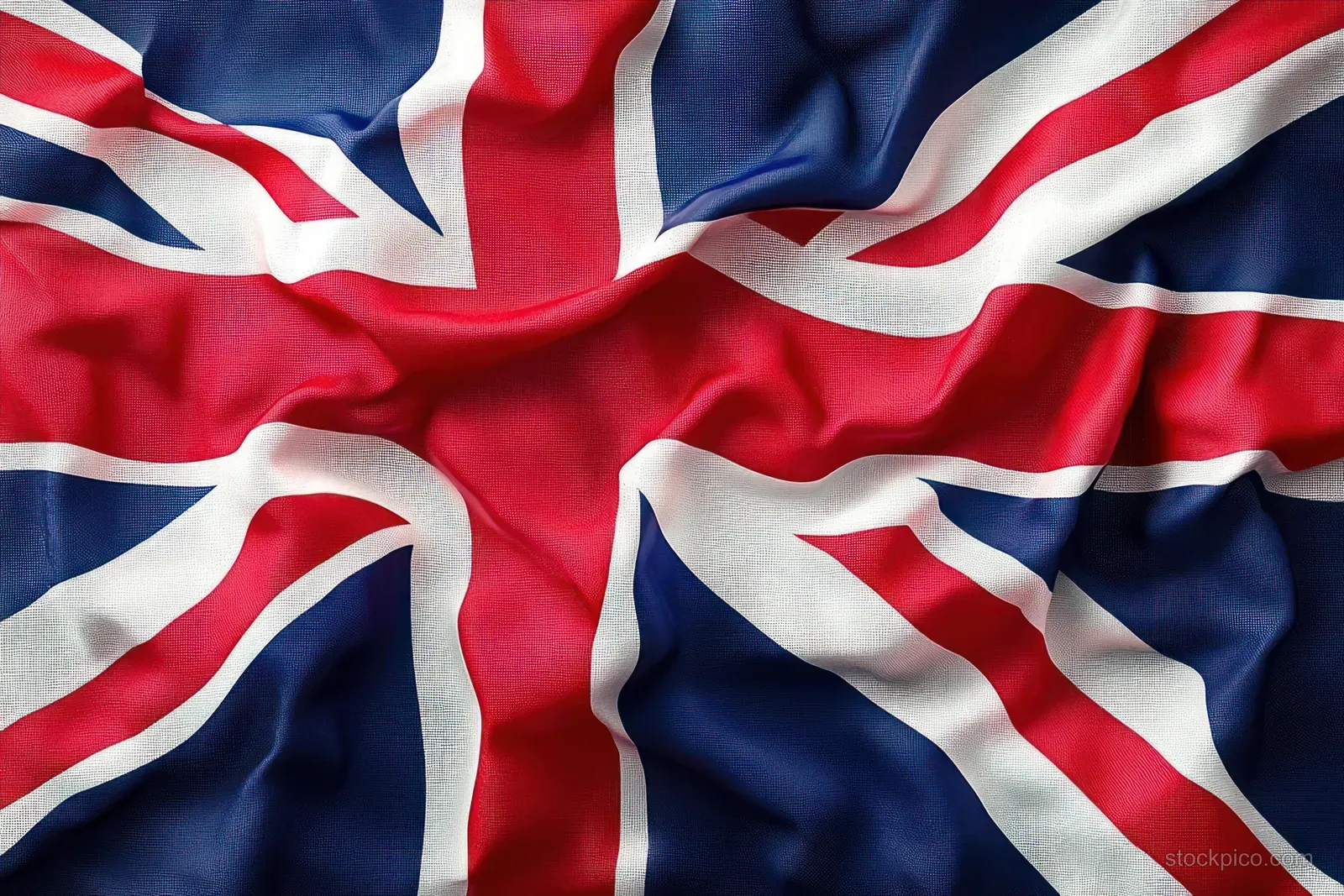 Wrinkled Union Jack fabric fills the frame with crossed red, white, and blue bands.