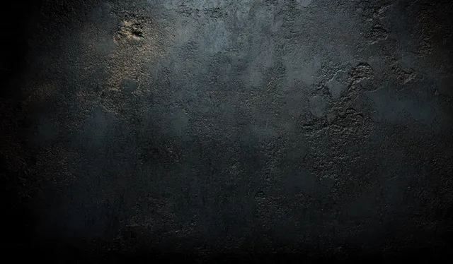 Close-up of a dark concrete wall texture with grunge stains, cracks, and soft ambient lighting.