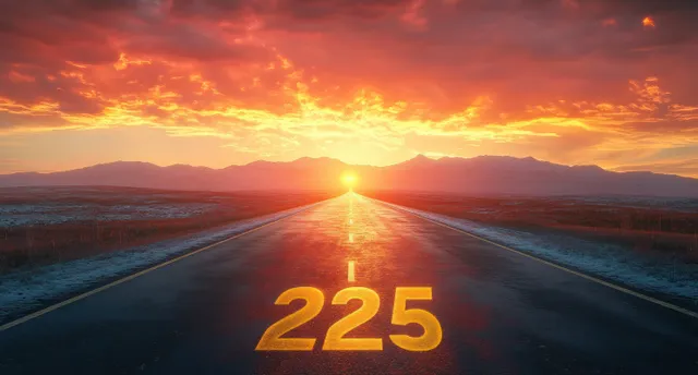 An empty highway at sunset with glowing road number 225 and fiery golden clouds toward distant mountains.